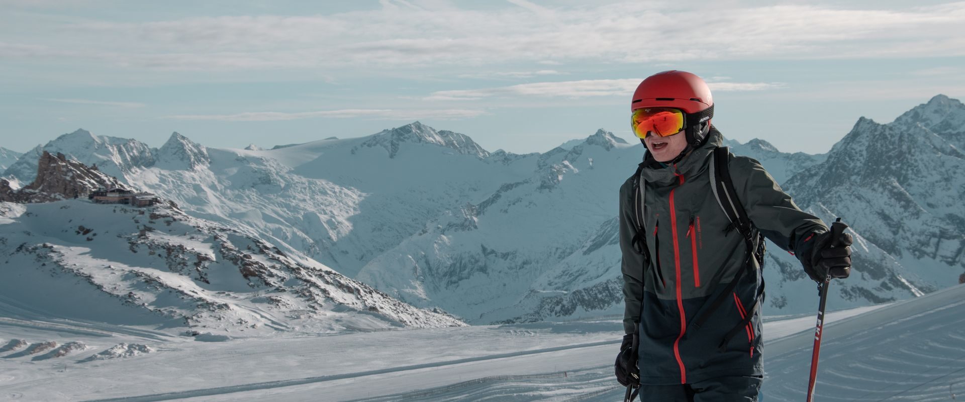 Skiløber i skijakke på vej ned ad bjerget