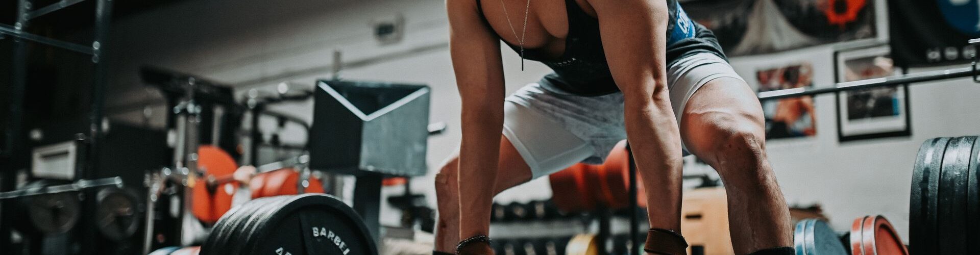 Mand løfter vægtstang i et fitnesscenter